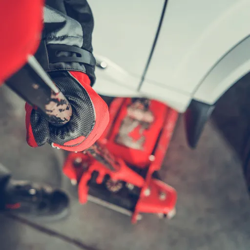 Technician in gloves performing professional DPF cleaning service with diagnostic equipment